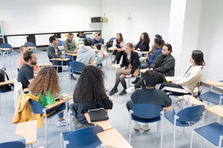 Sprachcafé_2 International students sit in two circles of chairs and talk.