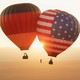 E_112021_Hasso-Plattner_cdn.evbuc.com_images_166610739.jpg 2 hot air balloons, one with the German flag and one with the US flag, float in the air