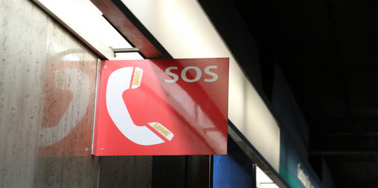 A red and white SOS sign