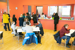 Eat and Read IBZ people standing and sitting together in the foyer of IBZ