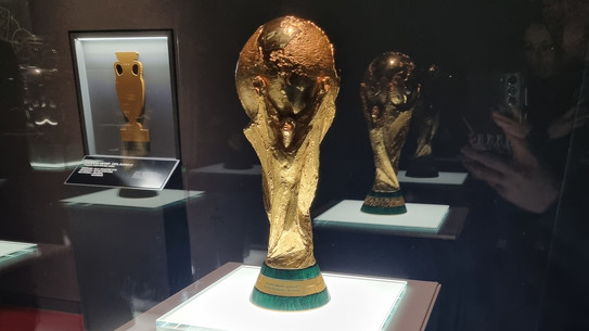 The trophy of the soccer world championship in a glass display.