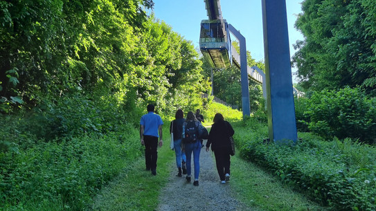 People walking below the H-Bahn.