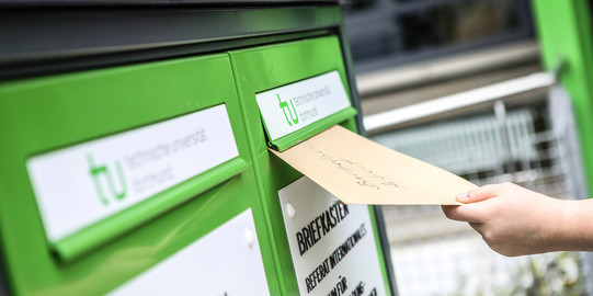 Fristenbriefkasten Eine Hand wirft einen Umschlag in den Fristenbriefkasten